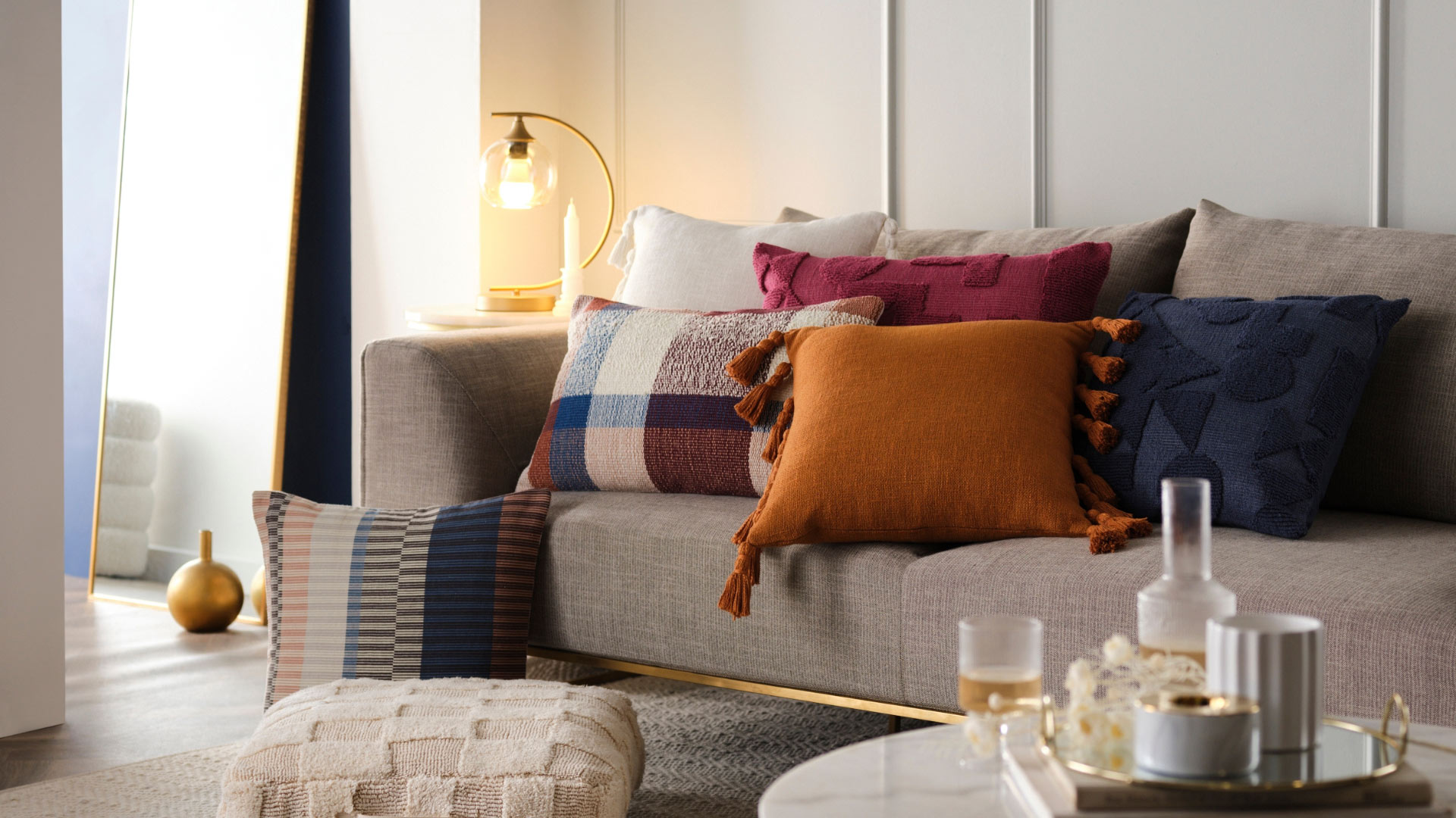 Assorted patterned and coloured tassel pillows on a couch